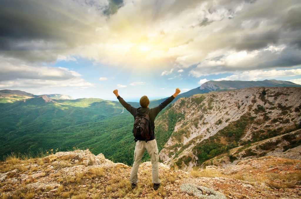 Man on top of mountain.